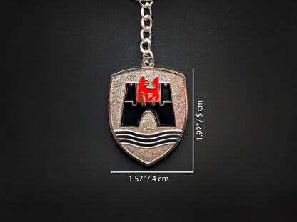 Dimensions of the VW Wolfsburg badge keychain showing a size of 1.97 inches by 1.57 inches (5 cm by 4 cm).